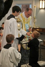 Boy recieving First Communion on tongue